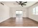 Bright living room featuring new wood floors, fresh white paint, and access to the outdoor patio at 3441 E Taylor St, Phoenix, AZ 85008
