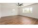 Spacious living room featuring new wood floors, fresh white paint, and a ceiling fan at 3441 E Taylor St, Phoenix, AZ 85008
