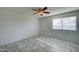 This bedroom features neutral paint, updated tile flooring, and a window for natural light at 3810 N Maryvale Pkwy # 1059, Phoenix, AZ 85031