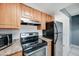 A kitchen showcasing wooden cabinets and modern appliances at 3810 N Maryvale Pkwy # 1059, Phoenix, AZ 85031