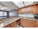 An updated kitchen space featuring wood cabinets, sleek appliances, and ample counter space at 3810 N Maryvale Pkwy # 1059, Phoenix, AZ 85031