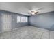 Well-lit living room boasting neutral tile floors and a ceiling fan at 3810 N Maryvale Pkwy # 1059, Phoenix, AZ 85031