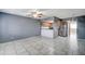 Open-concept living room with tile floors connected to the kitchen and stainless steel appliances at 3810 N Maryvale Pkwy # 1059, Phoenix, AZ 85031