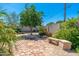 Lush backyard featuring mature trees, stone pavers, and gravel landscaping creating a tranquil retreat at 3822 W Flower St, Phoenix, AZ 85019