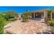 Expansive backyard with covered patio, mature trees, and stone pavers creating a relaxing outdoor space at 3822 W Flower St, Phoenix, AZ 85019