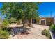 Lush backyard with stone pavers, mature trees, and shaded patio, perfect for outdoor entertaining at 3822 W Flower St, Phoenix, AZ 85019