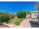 Serene backyard featuring a brick patio, lush greenery, and well-maintained landscaping, perfect for outdoor relaxation at 3822 W Flower St, Phoenix, AZ 85019