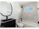 Bathroom featuring modern fixtures, vanity and a tiled shower-tub combination at 3822 W Flower St, Phoenix, AZ 85019