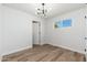 Bright bedroom featuring wood-style flooring and modern lighting fixture at 3822 W Flower St, Phoenix, AZ 85019
