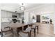 Bright dining area next to a modern kitchen features wood-look flooring and contemporary lighting at 3822 W Flower St, Phoenix, AZ 85019