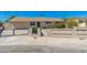 The property's entrance features a secure black metal fence and xeriscape yard, ensuring safety and low maintenance at 3822 W Flower St, Phoenix, AZ 85019