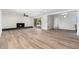 Bright open-concept living room featuring a fireplace and sliding glass doors to the outside at 3822 W Flower St, Phoenix, AZ 85019