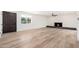 Spacious living room features wood-look flooring, fireplace and modern ceiling fan at 3822 W Flower St, Phoenix, AZ 85019