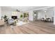 Bright open-concept living room with fireplace, wood-look flooring, neutral palette, and ample natural light at 3822 W Flower St, Phoenix, AZ 85019