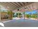 Covered patio featuring a ceiling fan, tile flooring, and lattice details for a relaxing outdoor space at 3822 W Flower St, Phoenix, AZ 85019