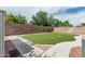 Landscaped backyard featuring synthetic grass, rock accents, concrete paver path, and block wall at 3856 E Encinas Ave, Gilbert, AZ 85234