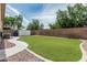 Backyard featuring synthetic grass, rock accents, white storage shed and concrete paver path at 3856 E Encinas Ave, Gilbert, AZ 85234