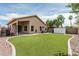Backyard with synthetic lawn, patio, and view of the home's exterior creates a low-maintenance outdoor retreat at 3856 E Encinas Ave, Gilbert, AZ 85234