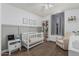 Bedroom with modern crib and neutral decor offers a comforting and inviting space for a  at 3856 E Encinas Ave, Gilbert, AZ 85234