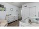 Bedroom featuring a closet, changing table, and crib with neutral tones is both calming and functional at 3856 E Encinas Ave, Gilbert, AZ 85234