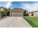 Charming single-story home with a well-manicured lawn and a two-car garage at 3856 E Encinas Ave, Gilbert, AZ 85234