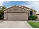 Close-up of a two-car garage with neutral paint and decorative tile roofing detail at 3856 E Encinas Ave, Gilbert, AZ 85234