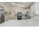 Bright kitchen featuring stainless steel appliances, white cabinets, and modern countertops at 3856 E Encinas Ave, Gilbert, AZ 85234