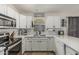 Kitchen featuring white cabinets, stainless steel appliances, and neutral countertop at 3856 E Encinas Ave, Gilbert, AZ 85234