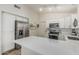 Spacious kitchen with stainless steel refrigerator, white cabinets and modern countertops at 3856 E Encinas Ave, Gilbert, AZ 85234