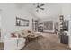 Bright living room featuring vaulted ceilings, a ceiling fan, neutral furniture, and carpeted floors at 3856 E Encinas Ave, Gilbert, AZ 85234