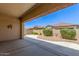 Covered back patio overlooking the fenced in backyard and desert landscaping at 3886 E Ficus Way, Gilbert, AZ 85298