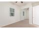 Bedroom featuring neutral walls, shuttered windows, and a closet with mirrored doors at 3886 E Ficus Way, Gilbert, AZ 85298