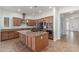 Spacious kitchen features stainless steel appliances, granite countertops, and a central island with a sink at 3886 E Ficus Way, Gilbert, AZ 85298