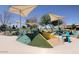 Community playground with climbing structures, slides, and shaded seating, perfect for outdoor fun and relaxation at 3886 E Ficus Way, Gilbert, AZ 85298