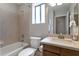 Cozy bathroom showcasing a bathtub and shower, a toilet, a sink, and neutral tiling creating a clean atmosphere at 3925 N 160Th Ave, Goodyear, AZ 85395