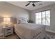 Inviting bedroom with a ceiling fan, a full-sized bed, a window, and soft light creates a peaceful atmosphere at 3925 N 160Th Ave, Goodyear, AZ 85395