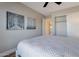 Neutral bedroom with a ceiling fan, artwork, closet, and a comfortable bed with white quilted bedding at 3925 N 160Th Ave, Goodyear, AZ 85395