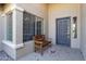 Inviting front porch with a wooden bench and neutral exterior colors at 3925 N 160Th Ave, Goodyear, AZ 85395