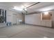 Spacious garage with epoxy floors, built-in cabinets for storage, a sink, and ample workspace at 3925 N 160Th Ave, Goodyear, AZ 85395