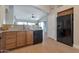 Well-lit kitchen featuring wooden cabinets, granite countertops, and modern black appliances, inviting culinary creativity at 3925 N 160Th Ave, Goodyear, AZ 85395