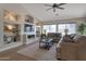Comfortable living room featuring built-in shelving and a ceiling fan at 3925 N 160Th Ave, Goodyear, AZ 85395