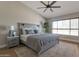 Relaxing main bedroom with a ceiling fan, light grey accents, and natural light filtering through the window at 3925 N 160Th Ave, Goodyear, AZ 85395