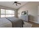 Bright main bedroom features a window, a ceiling fan, a dresser, and serene decor to create a tranquil space at 3925 N 160Th Ave, Goodyear, AZ 85395