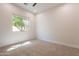 Well-lit bedroom with neutral carpet, white walls, and a window with a leafy outdoor view at 3971 E Leo Pl, Chandler, AZ 85249