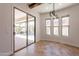 Bright dining area featuring tile floors, modern light fixture, and sliding glass doors to the pool at 3971 E Leo Pl, Chandler, AZ 85249