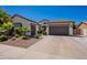 Charming single-story home featuring a three-car garage, desert landscaping, and a neutral color palette at 3971 E Leo Pl, Chandler, AZ 85249