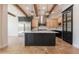 Modern kitchen with a central island, stainless steel appliances, and wood beam accents at 3971 E Leo Pl, Chandler, AZ 85249