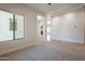 Open-concept living space with neutral carpet, offering seamless flow and ample natural light at 3971 E Leo Pl, Chandler, AZ 85249