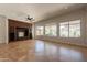 Elegant living room featuring a built-in entertainment center and large windows overlooking the backyard at 3971 E Leo Pl, Chandler, AZ 85249