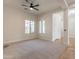 Bright and spacious living room with neutral carpet, ceiling fan, and plenty of natural light at 3971 E Leo Pl, Chandler, AZ 85249